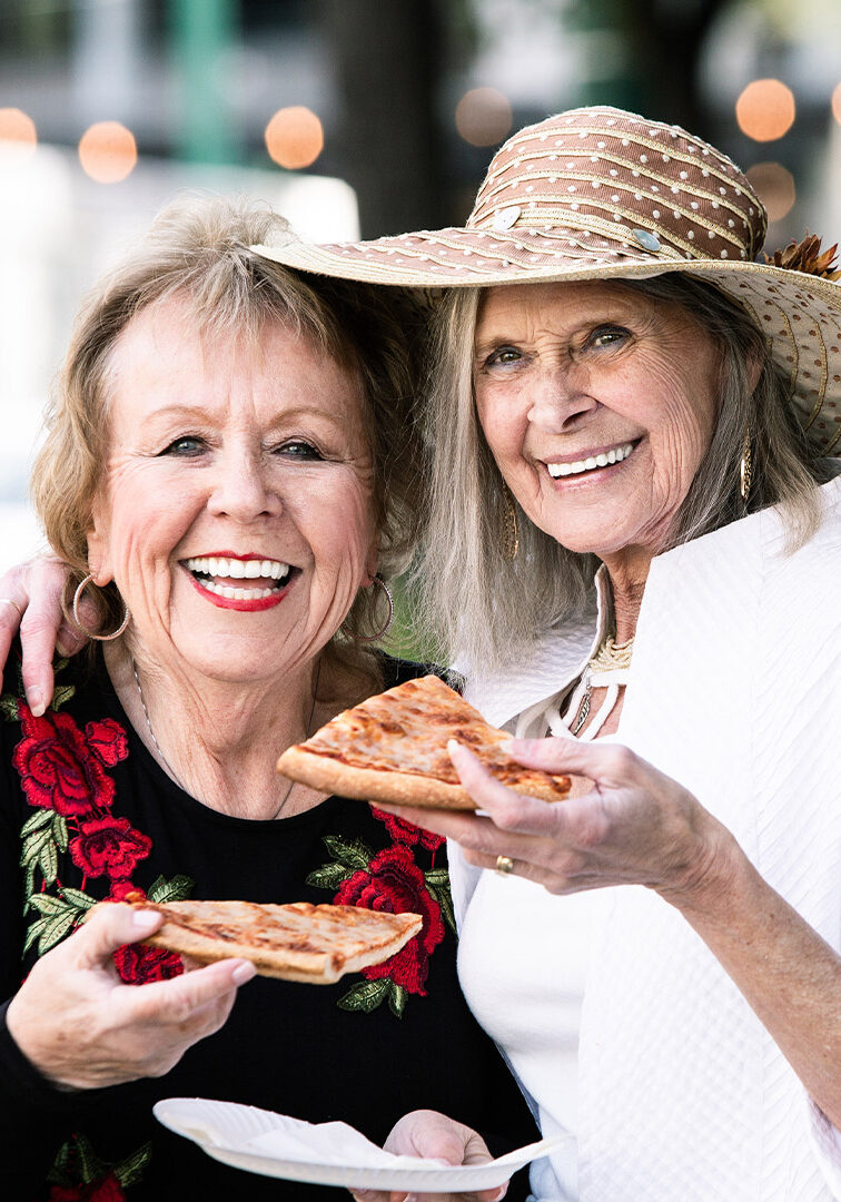 Senior Ladies Eating Pizza