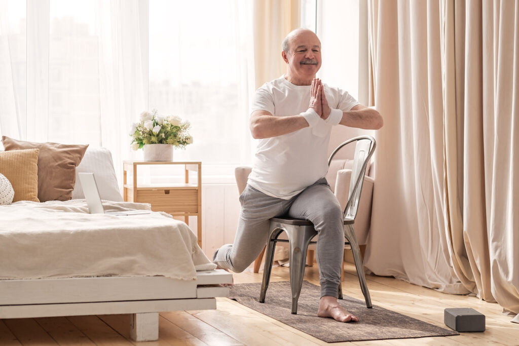 Older adult exercising at home.