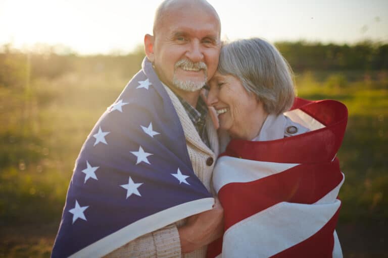 Veteran and spouse wrapped in American flag